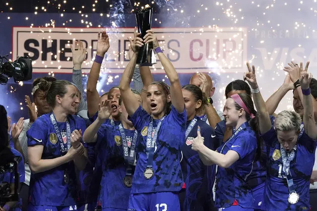 United States forward Alex Morgan, center, lifts the SheBelieves Cup with teammates after they won a soccer match against Brazil 2-0 Wednesday, February 22, 2023, in Frisco, Texas. (Photo by L.M. Otero/AP Photo)