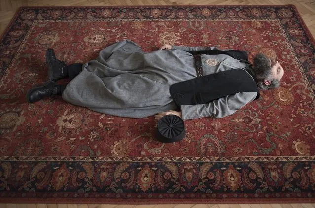 Greek Catholic metropolitan archbishop Fulop Kocsis stretches on the floor of his office in Debrecen, some 220 kms northeast of Budapest, Hungary, 14 December 2017. (Photo by Attila Balazs/EPA/EFE)