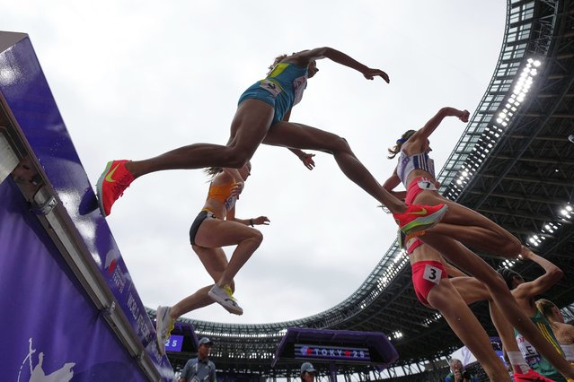 Runners compete in a heat of a women's 400 meters hurdles at the World Athletics Championships in Tokyo, Monday, September 15, 2025. (Photo by Ashley Landis/AP Photo)