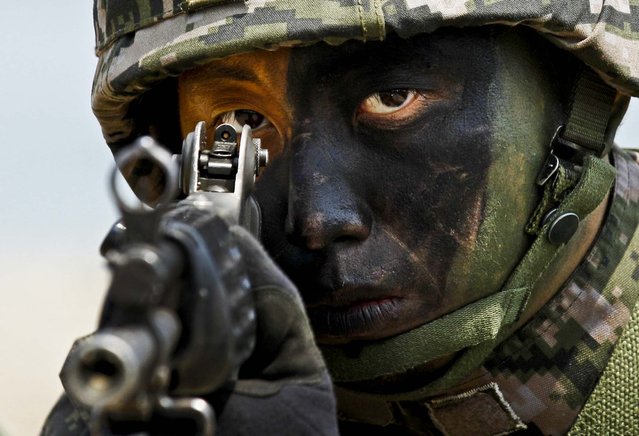 A South Korean Marine takes position during the joint military exercises between South Korea and the United States called Ssangyong 2013 as a part of annual Foal Eagle military exercises in Pohang, south of Seoul, South Korea, on April 26, 2013. (Photo by Kin Cheung/Associated Press)