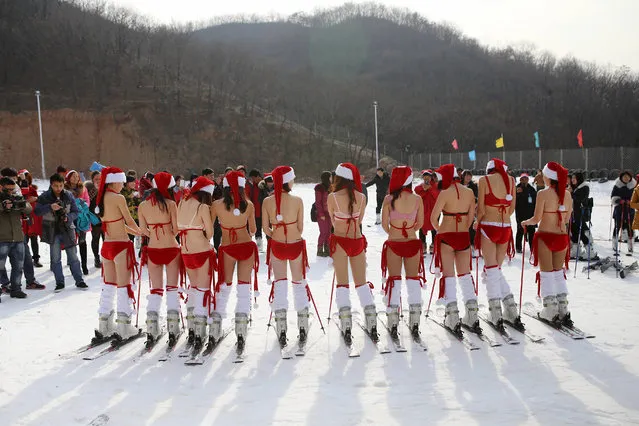 Women pose in Santa Claus-themed bikinis to promote ski resort on December 23, 2014 in Xuchang, China. (Photo by Feature China/Barcroft Media)