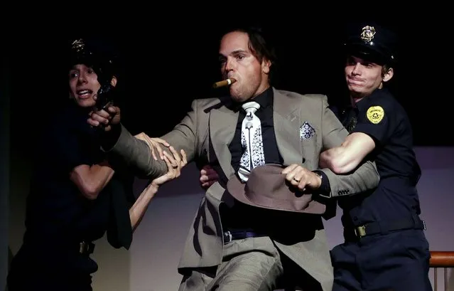 Former Major League Baseball catcher Mike Piazza is apprehended by police as he performs his role as a gangster during a dress rehearsal for Miami City Ballet's performance of Slaughter on Tenth Avenue. Piazza has a few lines in the company's May 3 production of the ballet George Balanchine choreographed as part of the 1930's musical “On Your Toes”. (Photo by Lynne Sladky/Associated Press)