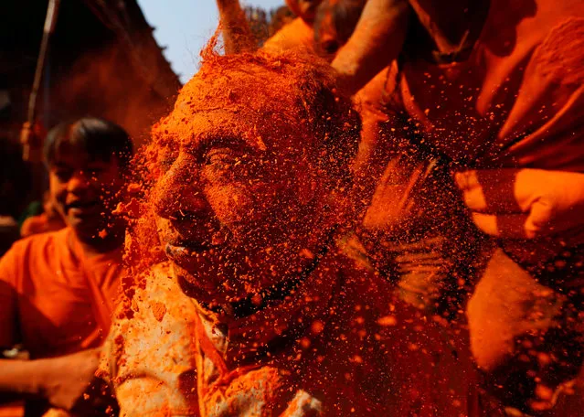 A devotee gets his face smeared with vermillion powder during “Sindoor Jatra” vermillion powder festival at Thimi, in Bhaktapur, Nepal April 15, 2018. (Photo by Navesh Chitrakar/Reuters)
