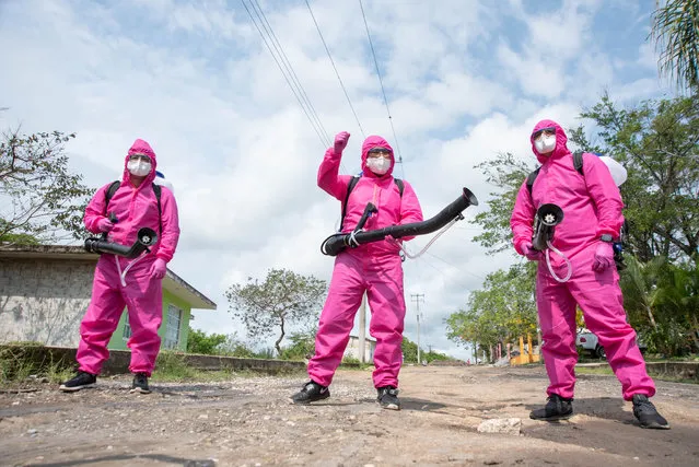 Health authority workers sanitise the rural community of Teocelo, Veracruz, Mexico on May 12, 2020 – in the hope of preventing the spread of COVID-19 infections. (Photo by Hector Adolfo Quintanar Perez/ZUMA Wire/Rex Features/Shutterstock)