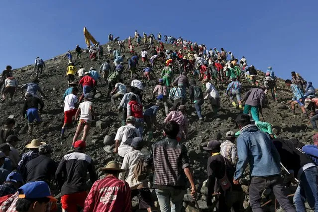 Miners search for jade stones at a mine dump in a Hpakant jade mine at Kachin state, Myanmar November 25, 2015. (Photo by Soe Zeya Tun/Reuters)