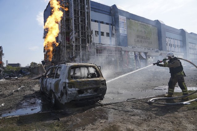 Firefighters extinguish the fire after a Russian missile attack in Kharkiv, Ukraine, Sunday, September 1, 2024. (Photo by Andrii Marienko/AP Photo)