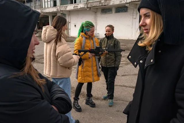 Katya, center, joins other Ukrainians as they attend a training on how to use weapons in the event of the Russians attack the city of Odessa, Ukraine, Tuesday, March 8, 2022. (Photo by Salwan Georges/The Washington Post)