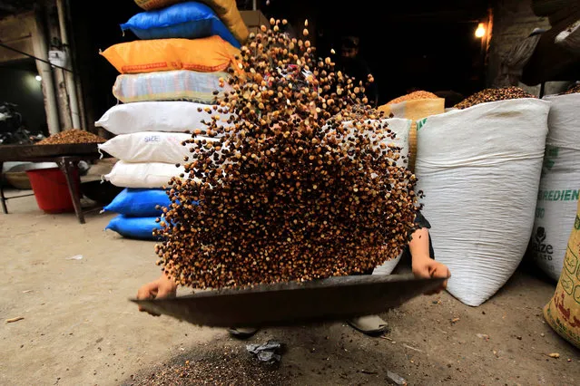 A Pakistani vendor prepares roasted nuts for sale at a nuts market in Peshawar, Pakistan, 05 January 2021. After a good raining season, the sales of dry fruits flourish in the country. Tourists from all over Pakistan come to Peshawar to purchase dry fruits along with other items because of price differences between different parts of the country. (Photo by Bilawal Arbab/EPA/EFE)