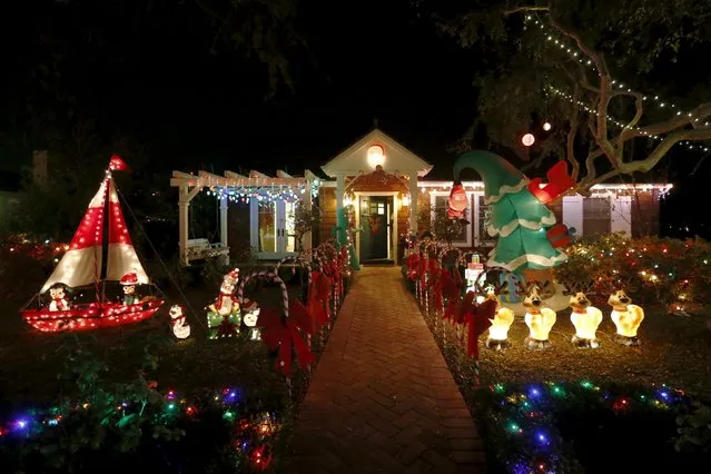 Christmas lights are seen on a home in the Sleepy Hollow area of Torrance, California, United States, December 15, 2015. In many neighborhoods of Los Angeles, homeowners compete for the most lavish and creative holiday light displays. Torrance's Sleepy Hollow is one such neighborhood where every home outdoes the next: surfing Santas, life-size nativity scenes, ferris wheels, and giant inflatable snowmen line the lawns on every street. (Photo by Lucy Nicholson/Reuters)