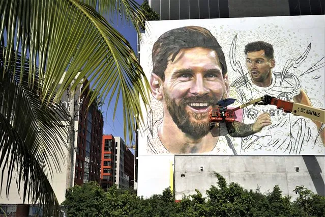 Artist Maximiliano Bagnasco paints a mural of Argentine soccer star Lionel Messi, Monday, July 10, 2023, in the Wynwood neighborhood of Miami. Murals, burgers, beers, and billboards are just a handful of examples that show the euphoria that Messi generates in South Florida and how he will be received when he lands for his new stage as a player with the Major League Soccer team Inter Miami. (Photo by Lynne Sladky/AP Photo)