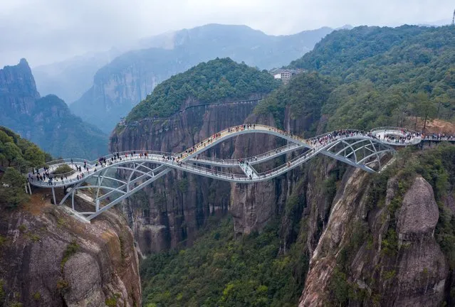 Photo taken from aerial view shows the “Ruyi Bridge” in the Shenxianju Scenic Area, which is shaped like a jade Ruyi in the sky, attracting many tourists to take pictures in Xianju county of Taizhou City, East China's Zhejiang Province, 24 March 2021. (Photo by Rex Features/Shutterstock)