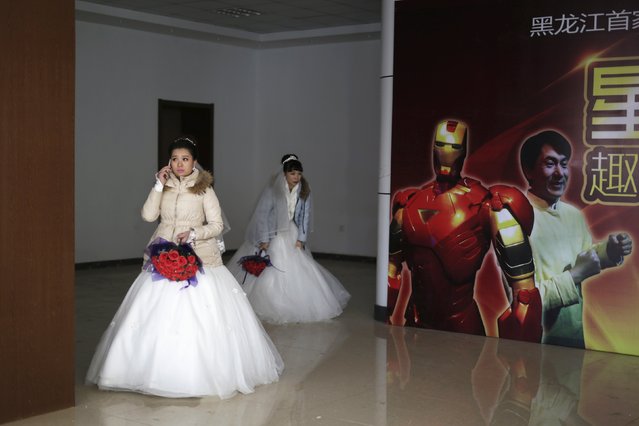 Newly-wed brides attend their group wedding ceremony at a park which was held as part of the Harbin International Ice and Snow Festival in the northern city of Harbin, Heilongjiang province January 6, 2016. (Photo by Aly Song/Reuters)