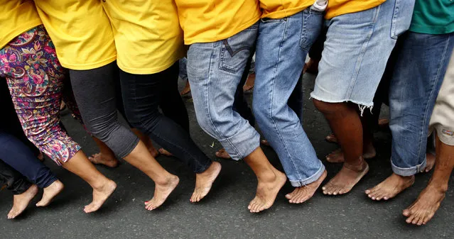 Barefooted devotees take part in a religious procession two days before the annual parade of the Black Nazarene in Manila, Philippines January 7, 2016. (Photo by Erik De Castro/Reuters)