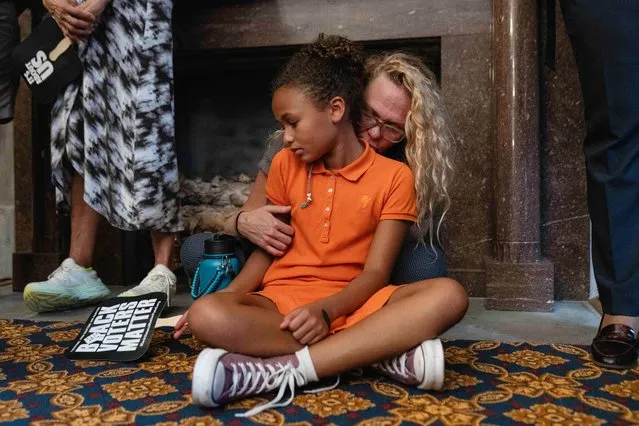 A woman embraces a child inside the Tennessee State House on the day of a special session on public safety to discuss gun violence in the wake of the Covenant School shooting in Nashville, Tennessee, U.S., August 21, 2023. (Photo by Cheney Orr/Reuters)