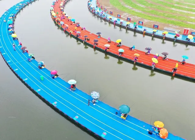 Aerial photo taken on May 15, 2021 shows the China Sihong Hongze Lake International Dayuan Pond Fishing Invitational Tournament in Suqian, Jiangsu Province, China. (Photo by Costfoto/Barcroft Media via Getty Images)