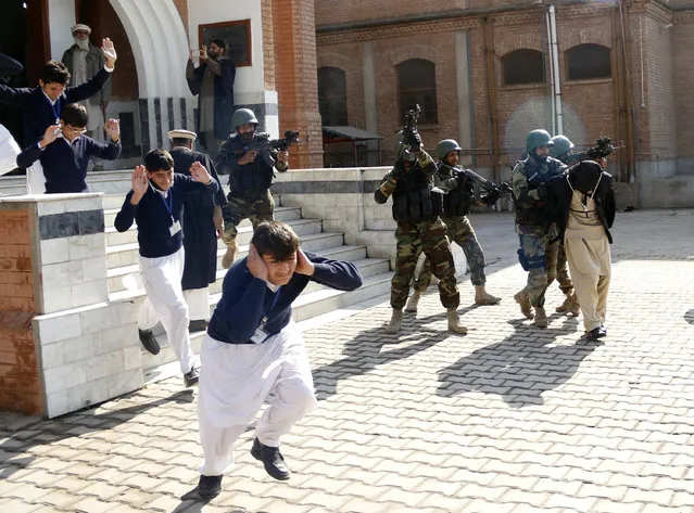 Schoolchildren flee as army soldiers conducting an exercise to repel militant attacks detain a mock-militant (R) at the Islamia Collegiate School in Peshawar, Pakistan February 02, 2016. (Photo by Khuram Parvez/Reuters)
