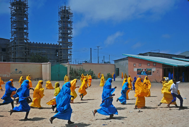 Somali school girls play football during lunch break at the Howlwadag Primary School in Howlwadag District, south of Mogadishu. on October, 5, 2016. (Photo by Mohamed Abdiwahab/AFP Photo)
