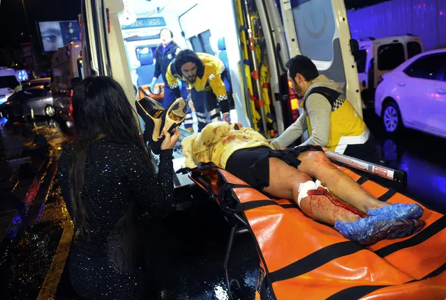 Medics carry a wounded person at the scene after an attack at a popular nightclub in Istanbul, early Sunday, January 1, 2017.  Istanbul Governor Vasip Sahin said that an armed assailant has opened fire at a nightclub in Istanbul during New Year's celebrations. Turkish authorities have banned distribution of images relating to the Istanbul attack within Turkey. (Photo by IHA via AP Photo)