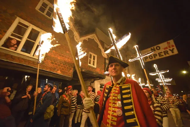 Torch-lit procession as part of the traditional Bonfire celebrations in Lewes, East Sussex on November 4, 2017. The event marks the anniversary of the foiled gunpowder plot of 1605 – a catholic plan to blow up parliament and King James. (Photo by Peter Cripps/Alamy Live News)