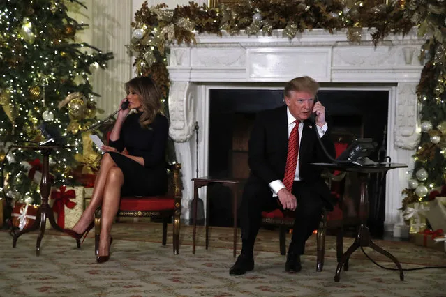 President Donald Trump and first lady Melania Trump each speak on the phone sharing updates to track Santa's movements from the North American Aerospace Defense Command (NORAD) Santa Tracker on Christmas Eve, Monday, December 24, 2018. (Photo by Jacquelyn Martin/AP Photo)