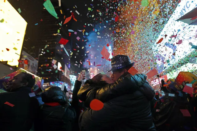 Joey and Claudia Flores, of California, kiss as confetti falls during a New Year's celebration in New York's Times Square, Tuesday, January 1, 2019. (Photo by Adam Hunger/AP Photo)