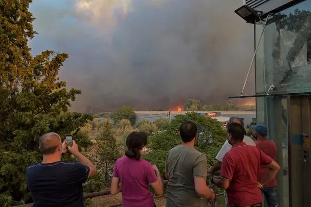 Local residents have evacuated their houses as wild fires in north suburbs of Athens on August 3, 2021 in Athens, Greece. People were evacuated from their homes after a wildfire reached residential areas of northern Athens as record temperatures were recorded at 42 degrees Celsius (107.6 Fahrenheit). (Photo by Milos Bicanski/Getty Images)