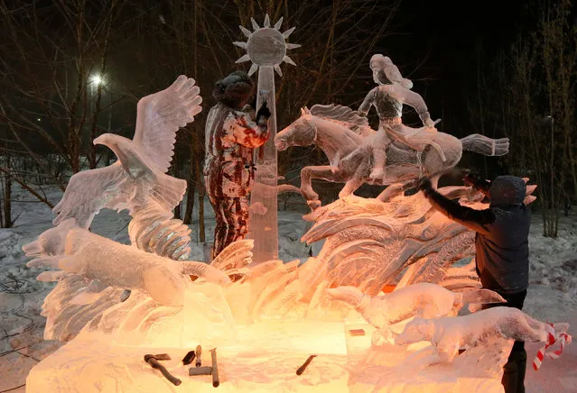 Members of the “Steppe Dwellers” team of Kazakhstan work on the ice sculpture called “Hunter” during the international festival of snow and ice sculptures  “The Magical Ice of Siberia” in Krasnoyarsk, Russia January 7, 2017. (Photo by Ilya Naymushin/Reuters)