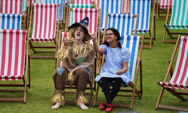 Aditi Jehangir as Dorothy and Ewan Shand as Scarecrow representing Wizard of Oz one of the popular films lined-up for this year's Film Fest in the City sit on deck chairs at an outdoor viewing area in St Andrew Square, as part of the Edinburgh International Film Festival on August 19, 2021. (Photo by Andrew Milligan/PA Images via Getty Images)