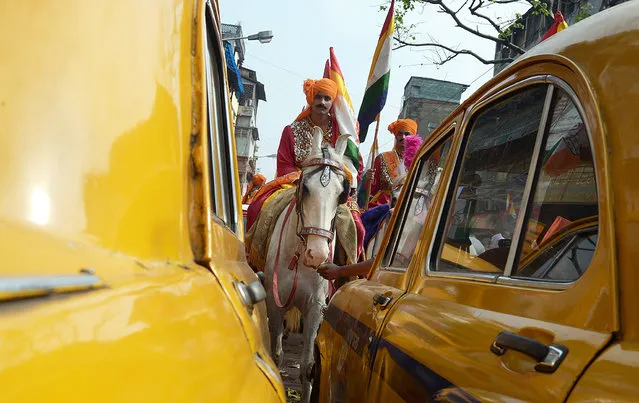 An young Indian Jain devotee dressed on a horse participates in a religious rally organised on the occasion of Mahavir Jayanti in Kolkata on April 2, 2015. The most important religious holiday in Jainism, Mahavir Jayanti celebrates the birth of Mahavira, the last Tirthankara, which is generally accepted as 599 BCE. (Photo by Dibyangshu Sarkar/AFP Photo)