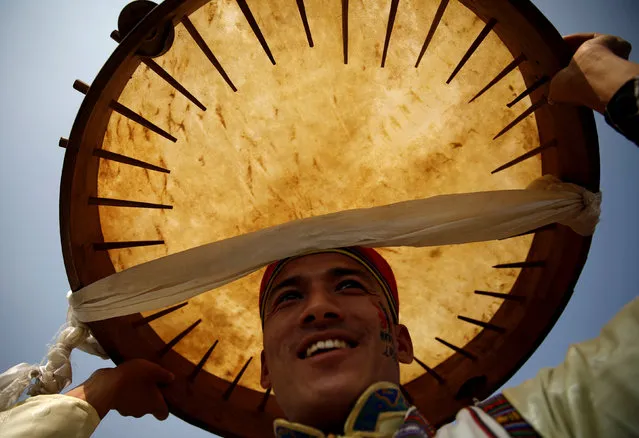 A man dressed in traditional attire holds a drum above his head as he sings and dances during the Sonam Lhosar in Kathmandu, Nepal February 5, 2019. Sonam Lhosar that occurs around the same time as the Chinese New Year marks the New Year of the Pig for the Tamang people, an ethnic indigenous group living in Nepal. (Photo by Navesh Chitrakar/Reuters)