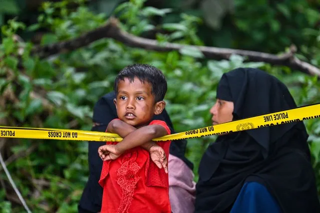 Rohingya refugees are seen at a beach on Sabang island, Aceh province on December 2, 2023. More than 100 Rohingya refugees, including women and children, landed in Indonesia's westernmost province on December 2, officials said, but locals threatened to push them back to sea. (Photo by Chaideer Mahyuddin/AFP Photo)