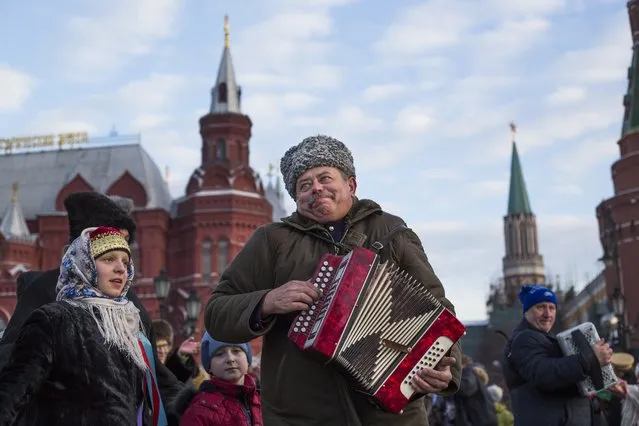 Men play accordions during a folk performance just off Red Square in Moscow, Russia, Wednesday, February 24, 2016. (Photo by Alexander Zemlianichenko/AP Photo)