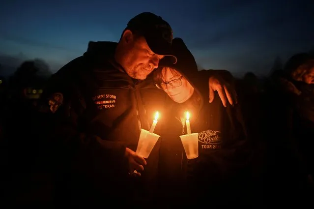Dan and Kathy Pratt embrace each other at a vigil, after a shooting at Perry High School, in Perry, Iowa, U.S., January 4, 2024. (Photo by Sergio Flores/Reuters)