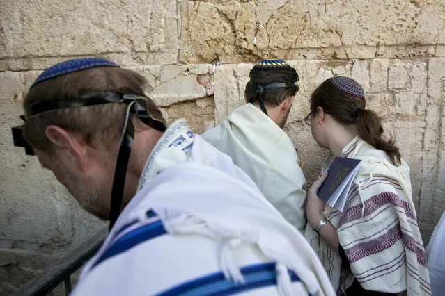 In this photo taken Thursday, February 25, 2016, American and Israeli Reform rabbis pray in the Western Wall, the holiest site where Jews can pray in Jerusalem's old city. A recent gathering of American Reform rabbis in Jerusalem was meant to celebrate the small gains the liberal Jewish movement has made in Israel in recent years. But a series of comments by Israeli leaders denigrating the group marred the event, reflecting an awkward relationship that many fear is alienating the world's second-largest Jewish community from Israel. (Photo by Sebastian Scheiner/AP Photo)