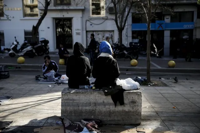 Two migrants sit on a marble bench on Victoria Square, where stranded refugees and migrants, most of them Afghans, find shelter in Athens, Greece, March 3, 2016. (Photo by Alkis Konstantinidis/Reuters)