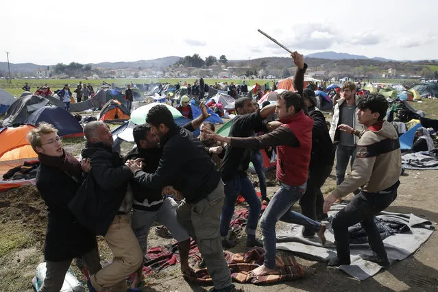 Migrants, who are waiting to cross the Greek-Macedonian border, fight between themselves at a makeshift camp near the village of Idomeni, Greece March 8, 2016. (Photo by Marko Djurica/Reuters)