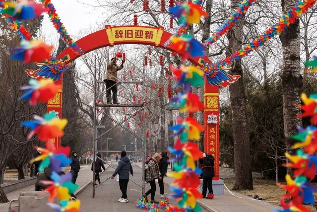 Workers put up decorations ahead of the Chinese Lunar New Year, at a park in Beijing, China on January 30, 2024. (Photo by Tingshu Wang/Reuters)