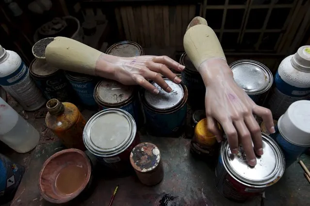 A set of wooden hands is seen at Jose Sabas Gomez's workshop in Apastepeque, El Salvador March 9, 2016. (Photo by Jose Cabezas/Reuters)