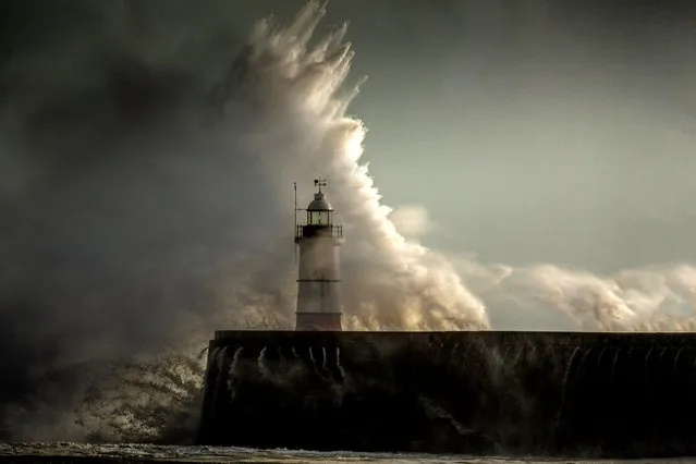 Huge waves break over the Newhaven Lighthouse on the south coast as another Altlantic storm hits Great Britain on February 12, 2014 in Newhaven, England.  (Photo by Christopher Furlong/Getty Images)