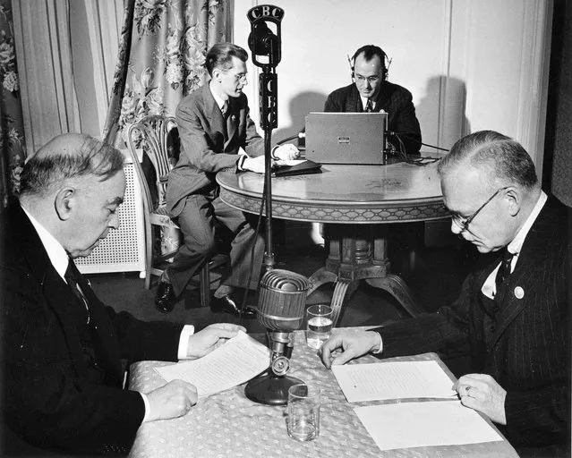 Canada's Prime Minister William Lyon Mackenzie King (L) and Minister of Justice Louis St. Laurent broadcast a message to Canada on VE-Day in an unknown location, May 8, 1945, in this handout photo provided by Library and Archives Canada. (Photo by Nicholas Morant/Reuters/National Film Board of Canada/Library and Archives Canada)