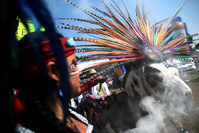 A woman leads her donkey during the annual donkey festival as part of May Day events in Otumba, near Mexico City on May 1, 2019. (Photo by Edgard Garrido/Reuters)
