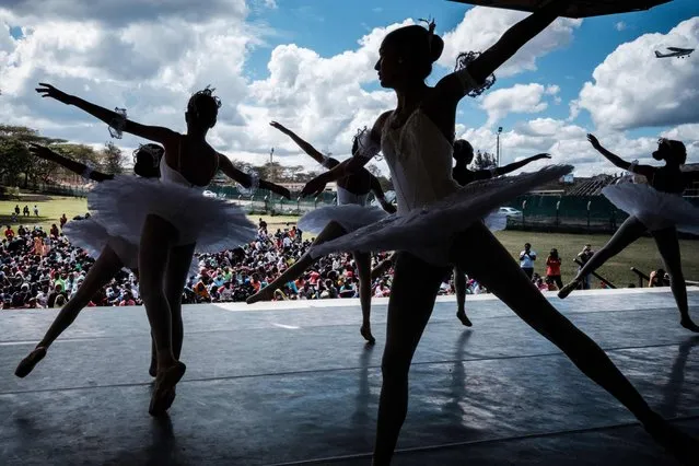 Members of Dance Centre Kenya (DCK) perform during a dress rehearsal of “Nutcracker”, a ballet primarily performed during the Christmas period, in front of about 1000 children invited from Kibera slum in Nairobi, on November 28, 2021. (Photo by Yasuyoshi Chiba/AFP Photo)