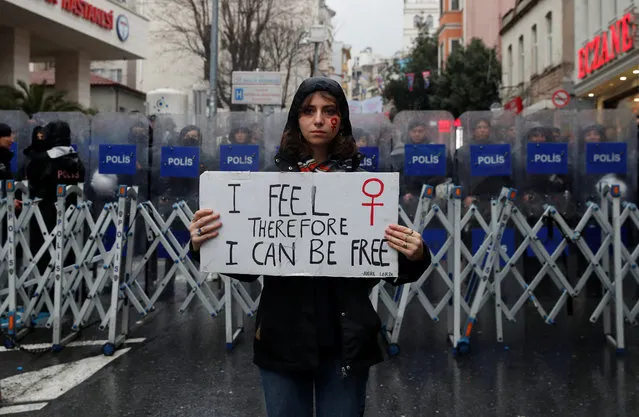 A demonstrator poses before the police barriers near Taksim Square, Istanbul, Turkey on March 8, 2024. (Photo by Dilara Senkaya/Reuters)