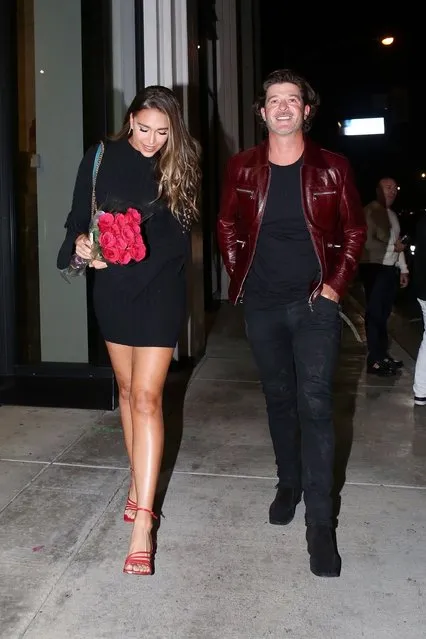 American singer-songwriter Robin Thicke and model April Love Geary seen at Catch LA on December 8, 2021 while out celebrating April's birthday. Holding a dozen roses April looked stunning in a black cozy dress. (Photo by Backgrid USA)