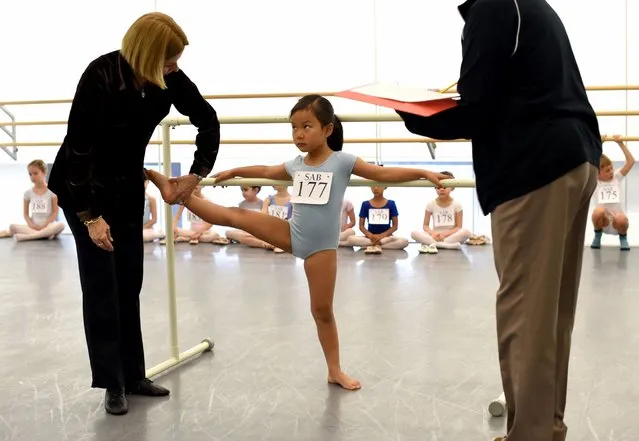 Six-year-old ballerina Julianna Chung receives instruction from School of American Ballet faculty members during spring auditions for 6-year-olds at the Lincoln Center in New York, April 11, 2016. (Photo by Timothy A. Clary/AFP Photo)