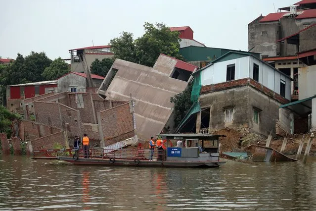 Collapsed buildings along the banks of Cau river in Bac Ninh province, Vietnam, 09 April 2024. Six houses collapsed on a dike of Cau river on 07 April 2024. Some 27 residents living in the houses were evacuated to safety, according to local authorities. (Photo by Luong Thai Linh/EPA)