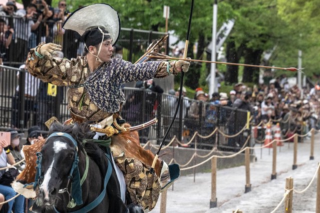 An archer in ancient samurai warrior uniform riding on a horse shoots an arrow to a target during a Yabusame horseback archery demonstration of the samurai martial arts at Sumida Park in Tokyo on April 20, 2024. (Photo by Yuichi Yamazaki/AFP Photo)
