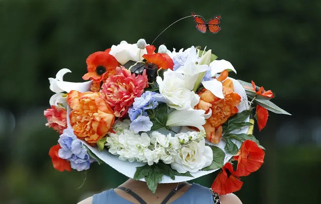 Pia Pelkonen wears a floral hat on the second day of the Royal Ascot horse racing meet at Ascot, England, Wednesday, June 17, 2015. Royal Ascot is the annual five day horse race meeting that Britain's Queen Elizabeth II attends every day of the event.(AP Photo/Alastair Grant)