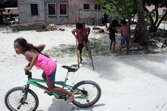 Children play on Kiritimati Island, part of the Pacific Island nation of Kiribati, April 5, 2016. (Photo by Lincoln Feast/Reuters)