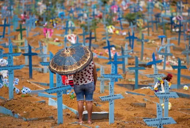 A woman visits the Nossa Senhora Aparecida cemetery on Mothers Day, in Manaus, Amazonas State, Brazil, on May 9, 2021, amid the COVID-19 novel coronavirus pandemic. Cemeteries in Brazil opened this weekend for the first time for the general public since the start of the COVID-19 pandemic. (Photo by Michael Dantas/AFP Photo)